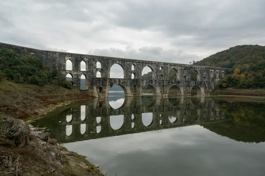 a large stone bridge over a body of water
